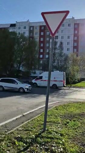 Emergency vehicle responds in Tobolsk during sunny afternoon
