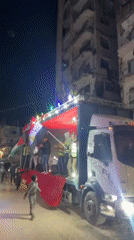 Flag-waving celebration on decorated truck observed in Gaza