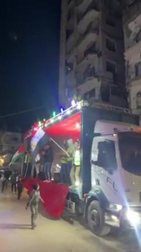 Flag-waving celebration on decorated truck observed in Gaza