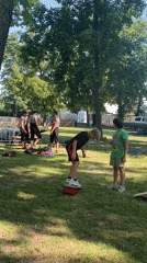 Street performers, rides, and crafts at a sunny park festival in Buk