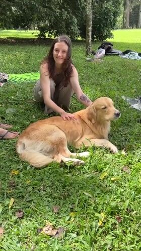 Couple enjoys early morning park time with golden retriever