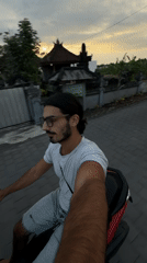Man rides scooter on road in North Kuta, Indonesia