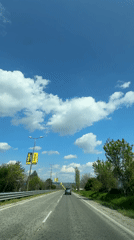 Vehicle travels sunny road in Byala, Bulgaria