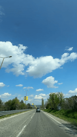 Vehicle travels sunny road in Byala, Bulgaria