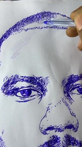 Artist sketches male portrait in blue ink in Jos