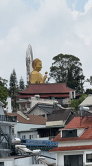 Golden Buddha statue with flower observed in Đà Lạt