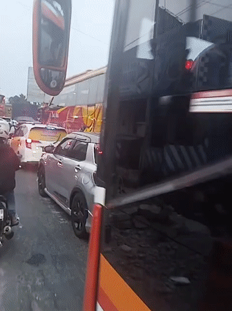 Heavy traffic observed on busy Indonesian road with tourism buses