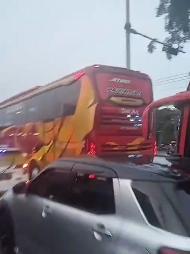 Heavy traffic observed on busy Indonesian road with tourism buses