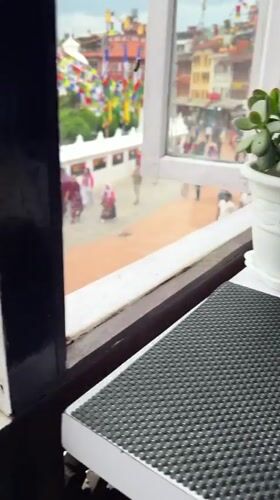 Tourist documents coffee break near Boudhanath Stupa in Nepal