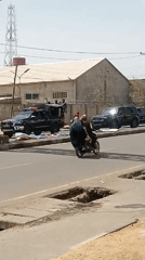 SUV convoy travels through busy Tudun Wada street traffic