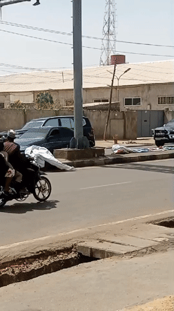 SUV convoy travels through busy Tudun Wada street traffic