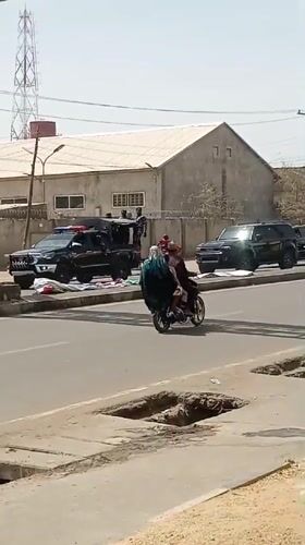 SUV convoy travels through busy Tudun Wada street traffic