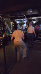 Moscow bar patrons dance, socialize during Friday evening gathering