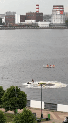 Water recreation observed on Izhevsk Pond amid cloudy conditions