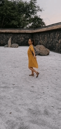 Tourist explores decorative stone courtyard in Hong Gai Ward