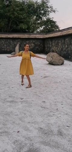 Tourist explores decorative stone courtyard in Hong Gai Ward