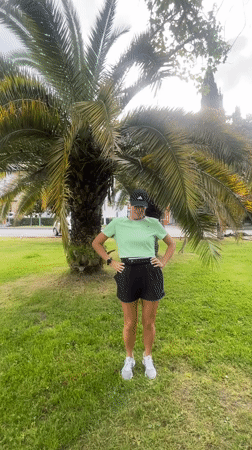 Woman exercises in Sochi park, cyclist spotted nearby