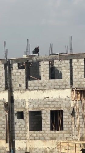 Construction workers active at Abuja building site