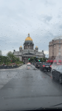 Rainy drive past a golden-domed cathedral in Saint Petersburg
