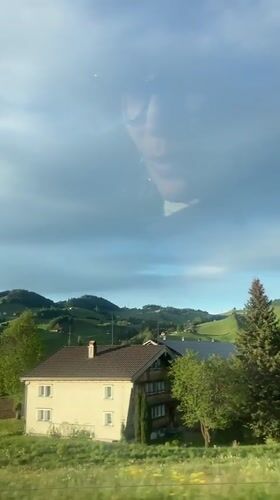 Swiss countryside view captured through window in Appenzell