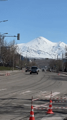 Daily traffic flows beneath mountains in Kamchatka city