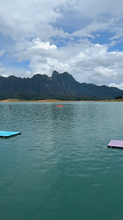 Backflip off a floating platform into a mountain lake