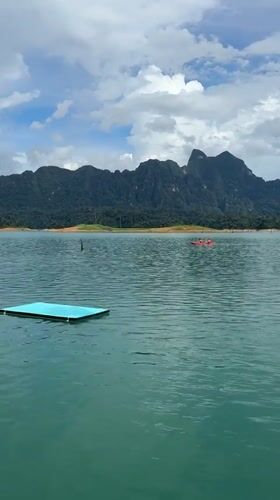 Backflip off a floating platform into a mountain lake