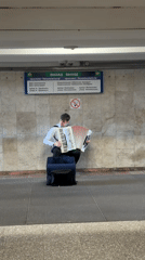 Street musician performs accordion in Belarus village