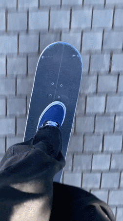 Skateboarder rides brick path in Badalona, Spain