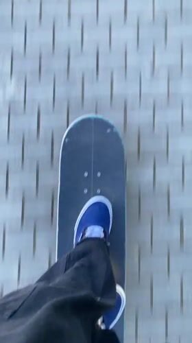Skateboarder rides brick path in Badalona, Spain