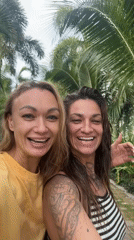 Two women film videos together in Vietnamese coastal towns