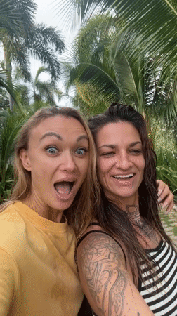 Two women film videos together in Vietnamese coastal towns