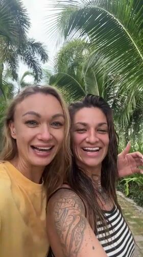 Two women film videos together in Vietnamese coastal towns