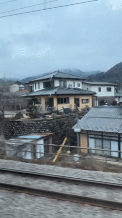 Train passenger films rural houses in Otsuki, Japan