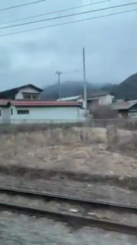 Train passenger films rural houses in Otsuki, Japan