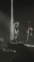 Live musical performance captured on dark stage in Paris