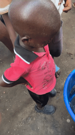 Nigerian market vendors conduct routine business operations