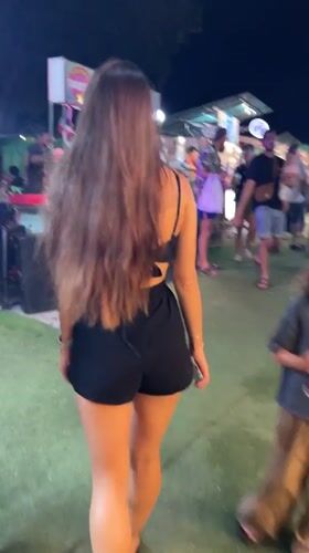 Woman browses night market food stalls in Thailand