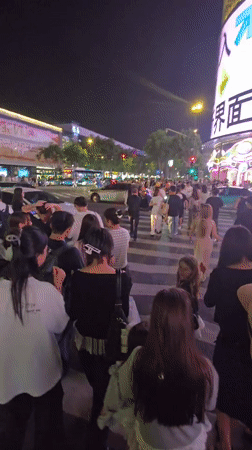 Busy nighttime shopping district activity captured in Shangcheng District