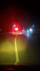 Driver encounters ambulance on dark Indonesian road at night