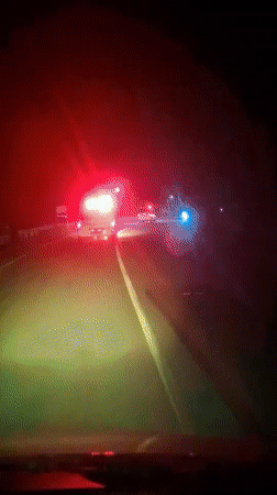 Driver encounters ambulance on dark Indonesian road at night