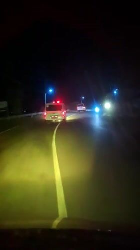Driver encounters ambulance on dark Indonesian road at night