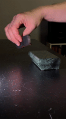 Young man performs fingerboard tricks on marble in Yekaterinburg