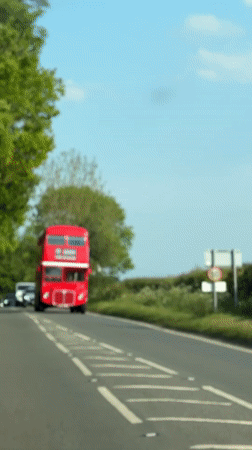 Double-decker bus travels countryside road near Amersham