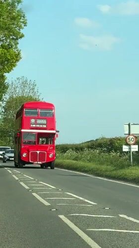 Double-decker bus travels countryside road near Amersham