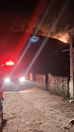 Hillside fire draws firefighters, onlookers in Lhokseumawe, Indonesia