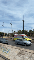 Valencia street scenes capture ambulance, blooming trees, construction activity