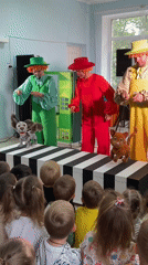 Costumed performers entertain children at early morning indoor show