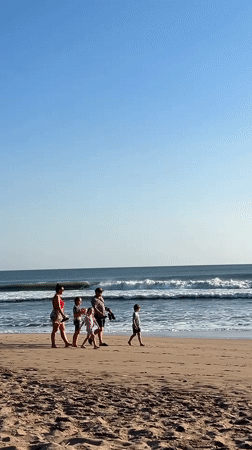 Morning beach life unfolds in Kuta, Indonesia