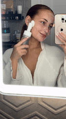 Woman documents evening skincare routine in Chaikovsky bathroom
